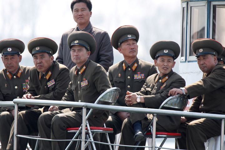 SINUIJU, NORTH KOREA - APRIL 10: (CHINA OUT) North Korean military officers sit onboard a ship at the frontier between China and North Korea on April 10, 2013 in Sinuiju, North Korea. South Korea and the United States are monitoring North Korea for a possible missile test launch April 10 officials were quoted by news reports as saying, amid heightened tensions. (Photo by ChinaFotoPress via Getty Images)