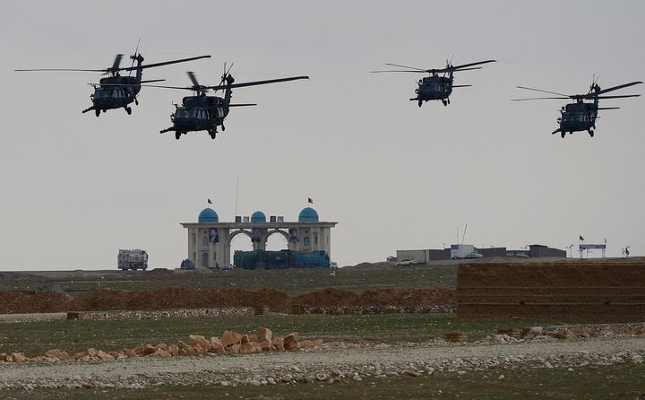  NATO-led International Security Assistance Force (ISAF) helicopters fly over the city of Mazar-i-Sharif on March 23, 2013. Karzai's office this week branded the NATO war effort in Afghanistan as 'aimless and unwise' in a row that erupted when he accused the US of working in concert with the Taliban to justify its presence in the country. AFP PHOTO/ SHAH Marai (Photo credit should read SHAH MARAI/AFP/Getty Images)