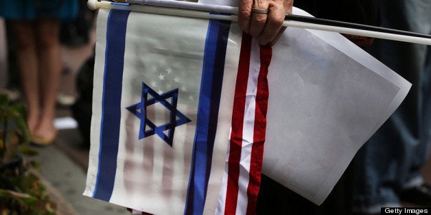 NEW YORK, NY - SEPTEMBER 27: A woman at a pro-Israel, anti-Iran rally holds American and Israeli flags on September 27, 2012 in New York City. Prime Minister Benjamin Netanyahu of Israel stated in a speech at the United Nations today that he believes Iran's ability to construct a nuclear weapon will be irreversible by next spring or summer. Over 120 prime ministers, presidents and monarchs are gathering this week at the United Nations for the annual General Assembly meeting. This year's focus among leaders will be the ongoing fighting in Syria, which is beginning to threaten regional stability. (Photo by Spencer Platt/Getty Images)