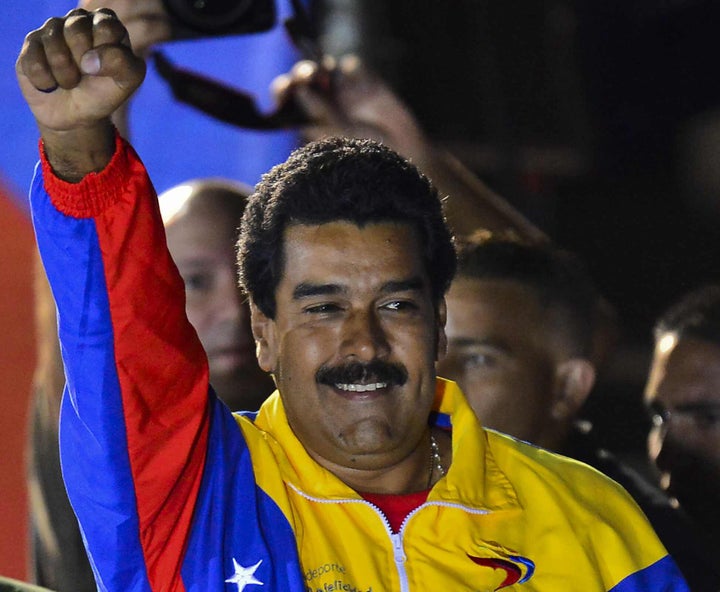 Venezuelan President elect Nicolas Maduro celebrates following the election results in Caracas on April 14, 2013. Fireworks erupted after the National Electoral Council announced that near complete results showed Maduro had won with just 50.66 percent of the vote compared to 49.1 percent for opposition rival Henrique Capriles -- a difference of less than 300,000 votes. AFP PHOTO/Luis Acosta (Photo credit should read LUIS ACOSTA/AFP/Getty Images)