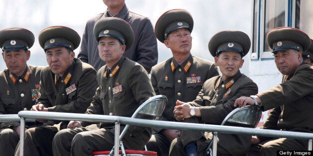 SINUIJU, NORTH KOREA - APRIL 10: (CHINA OUT) North Korean military officers sit onboard a ship at the frontier between China and North Korea on April 10, 2013 in Sinuiju, North Korea. South Korea and the United States are monitoring North Korea for a possible missile test launch April 10 officials were quoted by news reports as saying, amid heightened tensions. (Photo by ChinaFotoPress via Getty Images)