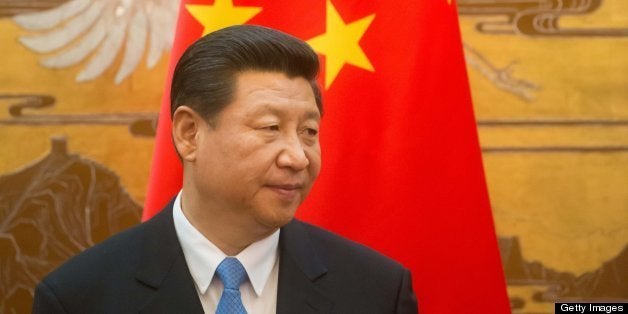 Chinese President Xi Jinping takes part in a signing contracts ceremony with his French counterpart Francois Hollande (unseen