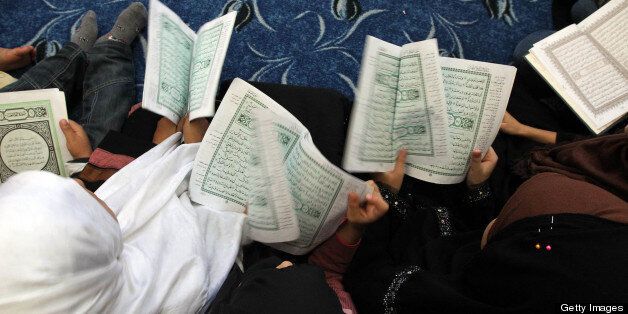 Libyan girls recite verses from the Koran, Islam's holy book, as they attend a religion lesson at the Sidi Abu Mingal mosque in Tripoli on October 12, 2011. AFP PHOTO/KARIM SAHIB (Photo credit should read KARIM SAHIB/AFP/Getty Images)