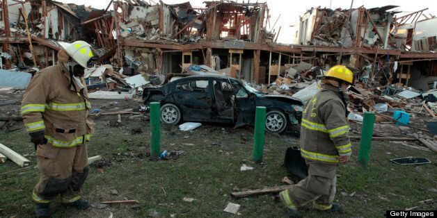 WEST, TX - APRIL 18: Valley Mills Fire Department personnel walk among the remains of an apartment complex next to the fertilizer plant that exploded yesterday afternoon on April 18, 2013 in West, Texas. According to West Mayor Tommy Muska, around 14 people, including 10 first responders, were killed and more than 150 people were injured when the fertilizer company caught fire and exploded, leaving damaged buildings for blocks in every direction. (Photo by Erich Schlegel/Getty Images)
