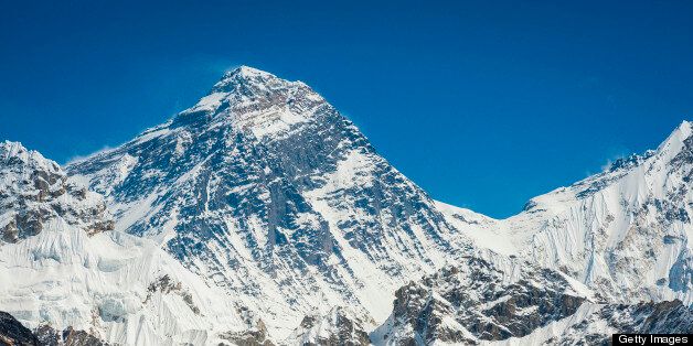 The iconic summit pyramid of Mt. Everest (8848m), the wind scoured south west face and snowy pass of the South Col under deep blue high altitude skies in the Himalaya mountains of the Sagarmatha National Park, Nepal. ProPhoto RGB profile for maximum color fidelity and gamut.