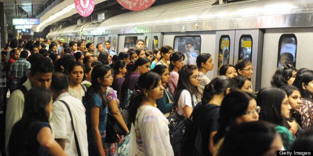 Indian commuters wait to travel at a Delhi Metro station in New Delhi on July 28, 2012. Over two million passengers Travel by Delhi metro and 2500 train trips are made each day. AFP PHOTO/RAVEENDRAN (Photo credit should read RAVEENDRAN/AFP/GettyImages)