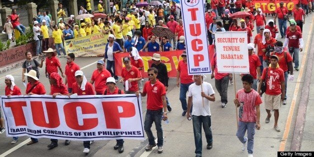 MANILA, PHILIPPINES - MAY 01: Labor groups and trade unions march near the presidential palace on May 1, 2013 in Manila, Philippines. The Philippines workers unions gather in the streets of Manila to demand, among other things, better pay, an end to contractualization and lower prices of basic commodities. Labor day is celebrated across South East Asia on May 1st and is seen as an opportunity to acknowledge the social and economic accomplishments of the workers. (Photo by Dondi Tawatao/Getty Images)