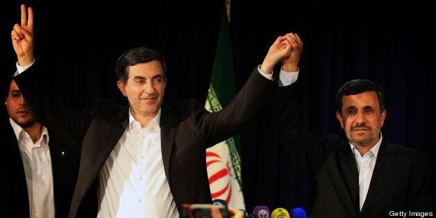 Iranian President Mahmoud Ahmadinejad (R) and Esfandyar Rahim Mashaie (L) wave during their press conference after Mashaie registered his candidacy for the upcoming presidential election at the interior ministry in Tehran on May 11, 2013. Iran is expected to wrap up the five-day registration of candidates on May 13, leaving the fate of the hopefuls in the hands of the Guardians Council, an unelected body controlled by religious conservatives appointed by Khamenei. AFP PHOTO/BEHROUZ MEHRI (Photo credit should read BEHROUZ MEHRI/AFP/Getty Images)