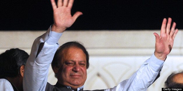 Former Pakistani prime minister and head of the Pakistan Muslim League-N (PML-N) Nawaz Sharif waves to supporters after his party victory in general election in Lahore on May 11, 2013. Sharif declared victory for his centre-right party in Pakistan's landmark elections on May 11, as unofficial partial results put him on course to win a historic third term as premier. The result represented a remarkable comeback for a man who was deposed as premier in a 1999 military coup and came after millions of people defied polling day attacks that left 24 dead to participate in the high-turnout vote. AFP PHOTO / ARIF ALI (Photo credit should read Arif Ali/AFP/Getty Images)