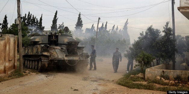 AFP EXCLUSIVE Syrian troops take control of the village of Western Dumayna, some seven kilometers north of the rebel-held city of Qusayr, on May 13, 2013. Syrian troops captured three villages in the strategic Qusayr area of Homs province, allowing them to cut supply lines to rebels inside Qusayr town, a military officer told AFP. AFP PHOTO/JOSEPH EID (Photo credit should read JOSEPH EID/AFP/Getty Images)