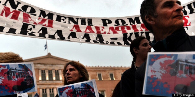 Protesters demonstrate outside the parliament against the austerity measures of Greek and Cypriot governments on March 31, 2013. AFP PHOTO / ARIS MESSINIS (Photo credit should read ARIS MESSINIS/AFP/Getty Images)