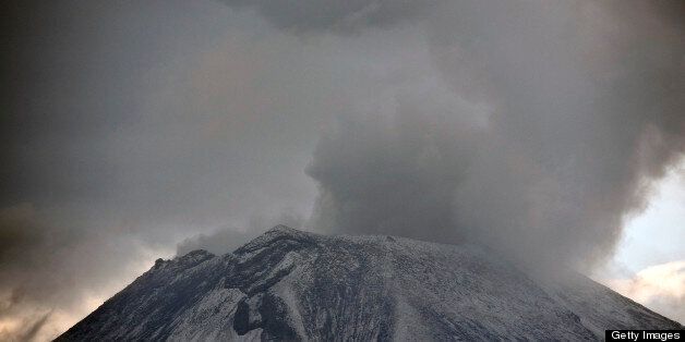 Clouds of ash and smoke are spewed from the Popocatepetl Volcano as seen from Santiago Xalitxintla, in Puebla, Mexico, on May 13, 2013. According to a report by the National Center of Prevention of Disasters (CENAPRED) the yellow alert phase three is still in force. AFP PHOTO /RONALDO SCHEMIDT (Photo credit should read Ronaldo Schemidt/AFP/Getty Images)
