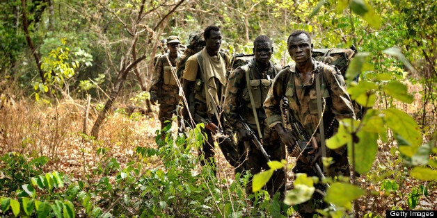 ADDITION / BYLINE TO GO WITH AFP STORY BY MAX DELANEY Ugandan soldiers patrol on April 18, 2012 through the central African jungle during an operation to fish out notorious Lord's Resistance Army (LRA) leader Joseph Kony. The unit is one of several dozen Ugandan army hunting squads -- backed up since late last year by 100 American special forces troops -- searching for any traces of the brutal rebel group in an inhospitable 400-kilometre stretch in the far eastern corner of the Central African Republic. The plan is to use the squads to constantly harry the rebels, who have splintered into small groups, denying them breathing space to regroup and resupply. And the Ugandan army says those tactics are paying off. AFP PHOTO/Yannick Tylle (Photo credit should read Yannick Tylle/AFP/Getty Images)