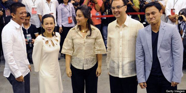 (From L to R) Francis Escudero, Grace Poe, Loren Legarda, Alan Peter Cayetano, and Sonny Angara, declared senators-elect by the Philippine Commission on Elections as some of the winners of the May 13 polls for 12 posts in the 24-seat Philippine Senate, gesture to the media in Manila on May 16, 2013. Initial figures show that followers of President Benigno Aquino are likely to win the bulk of these seats, boosting the chances of his reformist agenda. However the opposition coalition has objected to this, saying many votes are still uncounted and raising questions about the process. AFP PHOTO / Jay DIRECTO (Photo credit should read JAY DIRECTO/AFP/Getty Images)