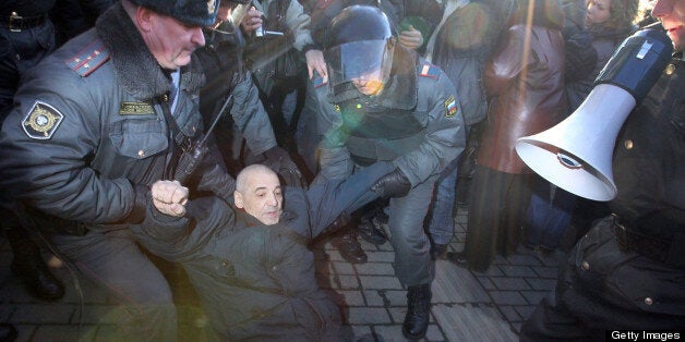 Russian riot police officers detain an opposition supporter during a rally to defend Article 31 of the Russian constitution, which guarantees the right of assemblies, in central Moscow on March 31, 2011. AFP PHOTO / ALEXEY SAZONOV (Photo credit should read Alexey SAZONOV/AFP/Getty Images)