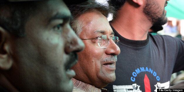 Former Pakistani president Pervez Musharraf (C) is escorted by soldiers and police commandos as he leaves an anti-terrorism court after a hearing in Islamabad on April 20, 2013. A Pakistani anti-terrorism court on April 20 extended former military ruler Pervez Musharraf judicial remand to prison for two weeks for sacking judges during his rule, officials said. AFP PHOTO / AAMIR QURESHI (Photo credit should read AAMIR QURESHI/AFP/Getty Images)