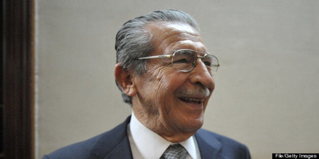 Former dictator and current lawmaker Efraín Ríos Montt smiles as he remains in a room of the Public Ministry to check whether there is an arrest warrant against him which could run on January 14, 2011, when he will lose his immunity as a deputy. AFP PHOTO Johan ORDONEZ. (Photo credit should read JOHAN ORDONEZ/AFP/Getty Images)