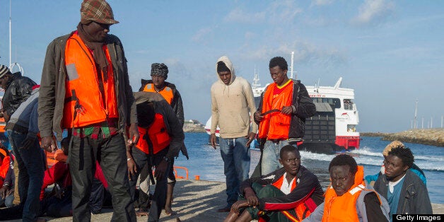 Would-be immigrants rest at Tarifa's harbour on April 22, 2013, after being rescued off the Spanish Coast. Spanish lifeguards today saved 32 African immigrants trying to cross the sea from Morocco to Spain in flimsy vessels, authorities said. A source in the lifeguard told AFP that Spanish rescuers hauled 32 migrants, of which all but one were men, from four vessels and took them to Tarifa on the southern tip of Spain. AFP PHOTO / MARCOS MORENO (Photo credit should read MARCOS MORENO/AFP/Getty Images)