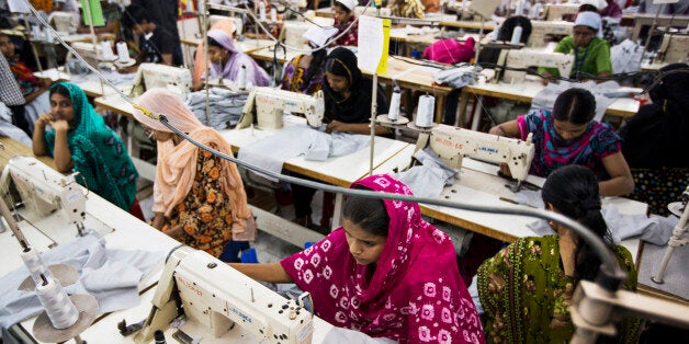 Workers sew garments on the production line of the Protik Apparels garment factory in Dhaka, Bangladesh, on Monday, April 29, 2013. Bangladesh authorities said they were accelerating rescue efforts at the factory complex that collapsed last week as hopes fade for more survivors after the nation's biggest industrial disaster. The government has decided to constitute a panel to identify garment factories in the country at risk of collapse, cabinet secretary Hossain Bhuiyan told reporters on April 29. Photographer: Jeff Holt/Bloomberg via Getty Images