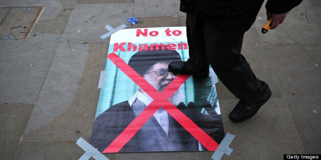 A protester steps on a poster of Iran's supreme leader Ayatollah Ali Khamenei during an opposition rally against the Iranian regime and the upcoming election in central London on May 15, 2013. AFP PHOTO/CARL COURT (Photo credit should read CARL COURT/AFP/Getty Images)