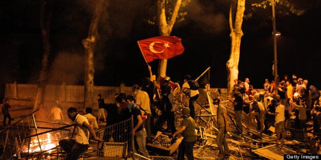 Protestors clash with riot police between Taksim and Besiktas in Istanbul, on June 1, 2013, during a demonstration against the demolition of the park. Turkish police on June 1 began pulling out of Istanbul's iconic Taksim Square, after a second day of violent clashes between protesters and police over a controversial development project. Thousands of demonstrators flooded the site as police lifted the barricades around the park and began withdrawing from the square. What started as an outcry against a local development project has snowballed into widespread anger against what critics say is the government's increasingly conservative and authoritarian agenda. AFP PHOTO/GURCAN OZTURK (Photo credit should read GURCAN OZTURK/AFP/Getty Images)