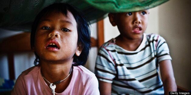 BATTAMBANG, CAMBODIA - 2007/12/01: Vimean, 4, and her younger brother Heng, 3, live at an orphanage. Vimean and Heng are both HIV-positive, and like 55,000 other children in Cambodia they lost their parents to AIDS. . (Photo by Jonas Gratzer/LightRocket via Getty Images)