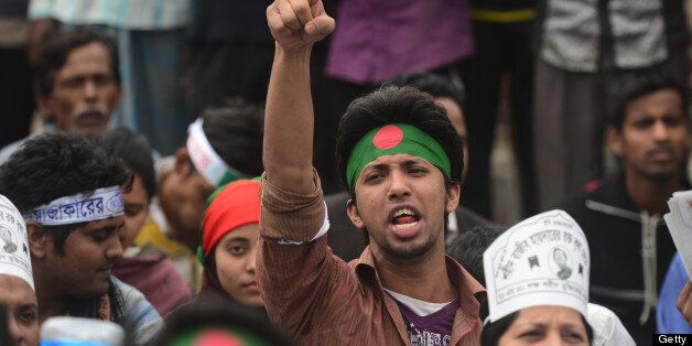 A Bangladeshi youth shouts slogans as Bangladeshi social activists and bloggers participate in a demonstration demanding the death sentence for the country's war criminals during a nationwide strike in Dhaka on February 18, 2013. One protester was shot dead as police fired rubber bullets at Islamists in a eastern town as a strike enforced by Bangladesh's largest Islamic party crippled life across the nation. AFP PHOTO/ Munir uz ZAMAN (Photo credit should read MUNIR UZ ZAMAN/AFP/Getty Images)