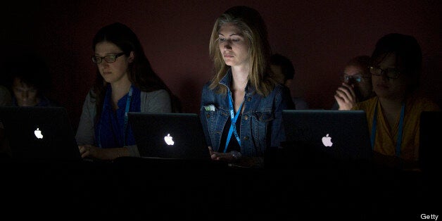 Bloggers work on Apple Inc. laptop computers during the LeWeb '13 conference in London, U.K., on Wednesday, June 5, 2013. Key web industry players attended the LeWeb London event which focused on the theme of the New Sharing Economy. Photographer: Simon Dawson/Bloomberg via Getty Images