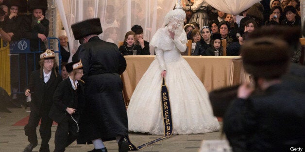 JERUSALEM, ISRAEL - MAY 22: Tens of thousands of Ultra-Orthodox Jews of the Belz Hasidic Dynasty watch the the bride Hannah Batya Penet dances with her relative during the wedding ceremony of Rabbi Shalom Rokach, the Grandson of the Belz Rabbi to Hana Batya Pener, early morrning of May 22, 2013. in Jerusalem, Israel. Some 25,000 Ultra-Orthodox Jews participated in one of the biggest weddings of the of Ultra-Orthodox Jewish community in the past few years. (Photo by Uriel Sinai/Getty Images)