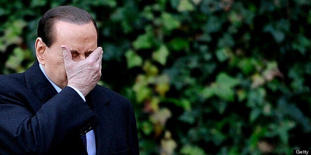 Italian Prime Minister Silvio Berlusconi holds his face in his hand at the Villa Madama in Rome as he arrives for a meeting with Slovenia's President Danilo Turk on January 18, 2011. Allegations that Prime Minister Silvio Berlusconi hooked up with prostitutes he kept in rent-free luxury apartments have weakened the government and damaged the country's image abroad, experts say. Italian magistrates last week announced an enquiry into the relationship between Berlusconi and an underage girl, known as Ruby, as the prime minister was still reeling from a court ruling partially stripping him of political immunity. AFP PHOTO / Filippo MONTEFORTE (Photo credit should read FILIPPO MONTEFORTE/AFP/Getty Images)