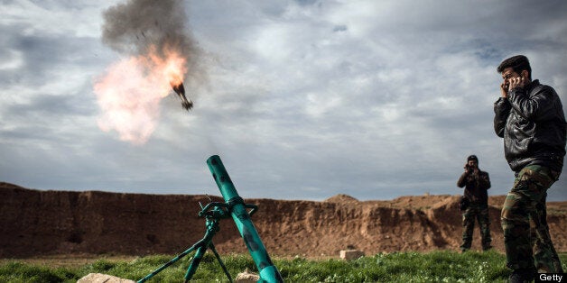 Syrian rebels fire a mortar towards regime forces stationed at Kwiriss airport in Al-Bab, 30 kilometres from the northeastern