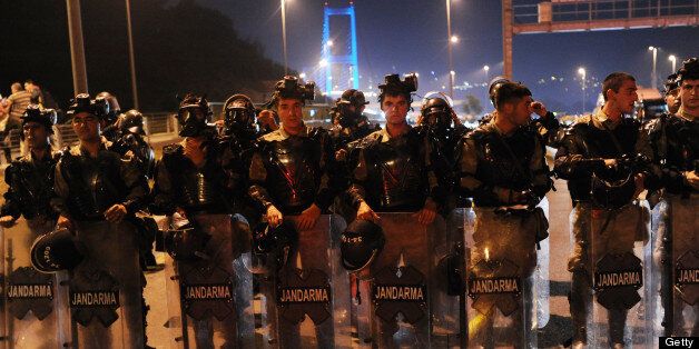 Turkish soldiers wait at the entrance of Bosphorus bridge on Anatolian side in Istanbul, on June 16, 2013. Police fired tear gas and jets of water to disperse hundreds of demonstrators in Istanbul's Taksim Square, shortly after Turkish Prime Minister Recep Tayyip Erdogan warned police would intervene to end protesters' occupation of a park bordering the square. Turkish protesters today had refused to budge from an Istanbul park at the centre of nationwide anti-government demonstrations after rejecting a government olive branch aimed at ending two weeks of deadly unrest. AFP PHOTO/BULENT KILIC (Photo credit should read BULENT KILIC/AFP/Getty Images)