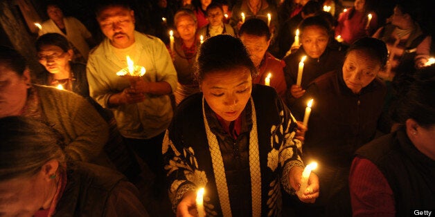 Tibetans-in-exile take part in a candlelight vigil following the self-immolation attempt by a monk earlier today, marking the one hundredth Tibetan to self immolate in protest against Chinese rule in Tibet, in Kathmandu on February 13, 2013. A Tibetan exile turned himself into a ball of fire in front of a Buddhist monument Wednesday, the 100th self-immolation attempt since 2009 in a wave of protests against Chinese rule. AFP PHOTO/Prakash MATHEMA (Photo credit should read PRAKASH MATHEMA/AFP/Getty Images)