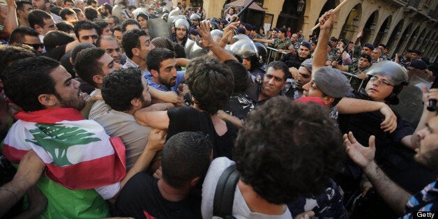 Lebanese left-wing demonstrators clash with security forces outside the parliament in the capital Beirut on June 20, 2013, during a demonstration against the extension of the mandate of the Lebanese parliament. Earlier in the month the Lebanese parliament extended its mandate by 17 months to November 2014, after failing to adopt a new electoral law at a time of deep divisions over the war in neighbouring Syria. AFP PHOTO / JOSEPH EID (Photo credit should read JOSEPH EID/AFP/Getty Images)