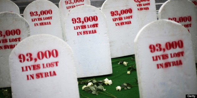 BELFAST, NORTHERN IRELAND - JUNE 17: Roses lie amongst rows of gravestones assembled by Oxfam symbolising the 93,00 people killed in Syria on June 17, 2013 in Belfast, Northern Ireland. The two day G8 summit, hosted by UK Prime Minister David Cameron, is being held in Northern Ireland for the first time. Leaders from the G8 nations have gathered to discuss numerous topics with the situation in Syria expected to dominate the talks. (Photo by Peter Macdiarmid/Getty Images)