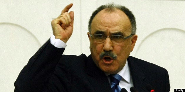 Turkish Interior Minister Besir Atalay addresses the parliament during a censure motion against him about his government's Ku