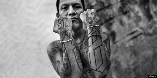 SAN SALVADOR, EL SALVADOR - MAY 13: A member of the 18th Street Gang (M-18) proudly shows off his gang tattoos on 13 May 2011 in San Salvador, El Salvador, . During the last two decades, Central America has become the deadliest region in the world that is not at war. According to the UN statistics, more people per capita were killed in El Salvador than in Iraq, in recent years. Due to the criminal activities of Mara Salvatrucha (MS-13) and 18th Street Gang (M-18), the two major street gangs in El Salvador, the country has fallen into the spiral of fear, violence and death. Thousands of Mara gang members, both on the streets or in the overcrowded prisons, organize and run extortions, distribution of drugs and kidnappings. Tattooed armed young men, mainly from the poorest neighborhoods, fight unmerciful turf battles with their coevals from the rival gang, balancing between life and death every day. Twenty years after the devastating civil war, a social war has paralyzed the nation of El Salvador. (Photo by Jan Sochor/Latincontent/Getty Images)