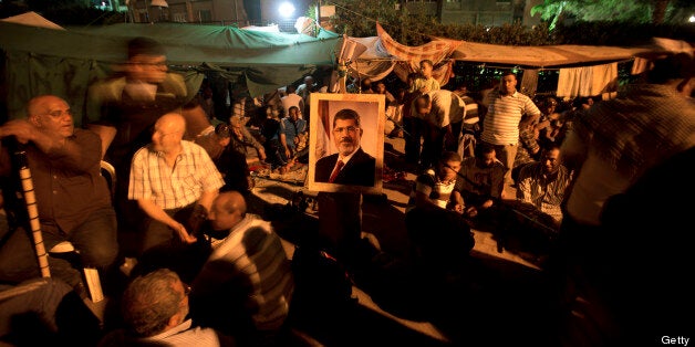 An Egyptian supporters of the Muslim Brotherhood prays on July 7, 2013 during a rally in support of deposed President Mohamed Morsi outside the Rabaa al-Adawiya mosque in Cairo. Islamists erected barricades across the capital, where tens of thousands of them blocked the main road to the international airport. AFP PHOTO / MAHMUD HAMS (Photo credit should read MAHMUD HAMS/AFP/Getty Images)