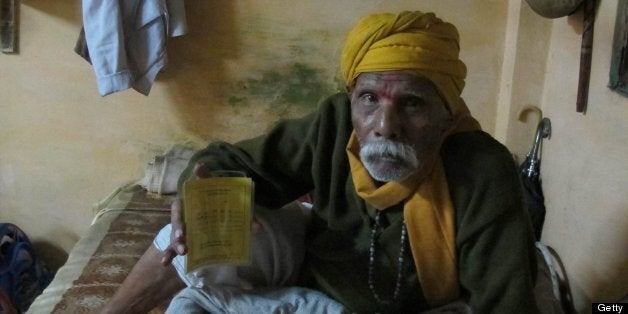 MADHYA PRADESH, INDIA - NOVEMBER 26: Niranjan Lal Pathak, 85, an Alzhiemer's Disease patient was tested for a placebo-controlled drug trial for a heart illness drug in 2008 and 2009. The yellow card he holds is the only evidence now that provees that he was part of a drug trial. His family says the doctors treated them very kindly, gave free medicines and paid commuting costs, but did not tell them that a trial was being conducted. They signed a form without reading or fully understanding. Scores of Indians are now saying that they did not give informed consent for drug trials -- fueling fears that Indian patients may be the new guinea pigs for the global pharmaceutical companies. Over 1700 patients who took part in drug trials have died between 2007 and 2010. Last year 22 families of the dead received compensation money from 10 drug companies in 2010. At present an estimate of 150,000 Indians are undergoing drug trials across India. (Photo by Rama Lakshmi/The Washington Post via Getty Images)