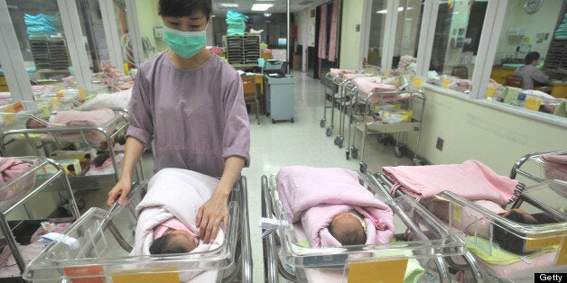A nurse inspects a newborn baby at a nursery in a hospital in Taipei on July 8, 2011. Taiwan's birth rate rose for the first