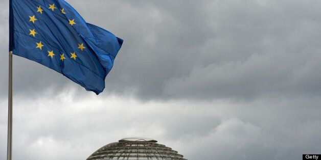 A flag of the European Union (EU) waves in front of a cloudy sky above the dome of the Reichstag building in Berlin, Germany, on July 11, 2013. AFP PHOTO / DPA / SOEREN STACHE +++ GERMANY OUT (Photo credit should read SOEREN STACHE/AFP/Getty Images)