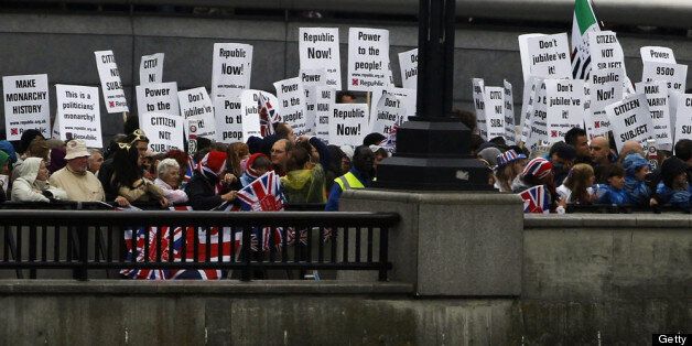 LONDON, ENGLAND - JUNE 03: Anti-monarchy protestors hold placards on the banks of the Thames during the Diamond Jubilee Thames River Pageant on June 3, 2012 in London, England. For only the second time in its history the UK celebrates the Diamond Jubilee of a monarch. Her Majesty Queen Elizabeth II celebrates the 60th anniversary of her ascension to the throne. Thousands of well-wishers from around the world have flocked to London to witness the spectacle of the weekend's celebrations. The Queen along with all members of the royal family will participate in a River Pageant with a flotilla of a 1,000 boats accompanying them down The Thames. (Photo by Suzanne Plunkett - WPA Pool /Getty Images)