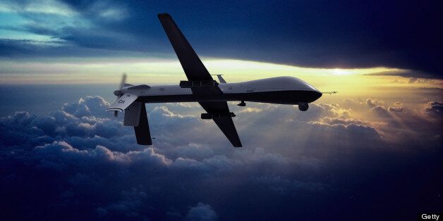 MQ-1 Predator Unmanned Drone with Hellfire Missiles Flying at Sunset