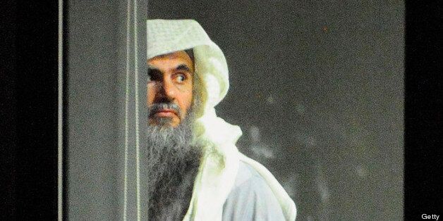 LONDON, ENGLAND - JULY 7: (NO SALES) (EDITORIAL USE ONLY) In this handout image provided by the MoD, radical cleric Abu Qatada (L) prepares to board a plane at RAF Northolt which will take him to Jordan, after he was deported from the UK to face terrorism charges in his home country, on July 7, 2013 in London, England. (Photo by Sgt Ralph Merry/MoD via Getty Images)