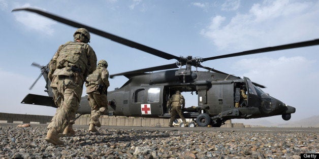 US soldiers from the 10th Mountain Division practice medical evcuation skills during a training session at the Forward Operating Base Ghazni on May 24, 2013. US-led coalition forces are winding down their operations before a scheduled withdrawal of the bulk of their 100,000 troops by the end of 2014, and racing to prepare Afghan forces to take over responsibility for security. AFP PHOTO/Dibyangshu SARKAR (Photo credit should read DIBYANGSHU SARKAR/AFP/Getty Images)