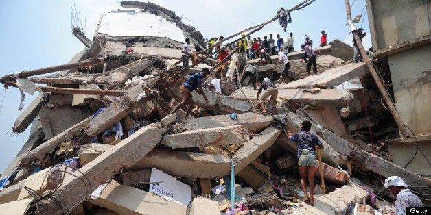 Bangladeshi volunteers and rescue workers are pictured at the scene after an eight-storey building collapsed in Savar, on the outskirts of Dhaka, on April 25, 2013. Survivors cried out to rescuers April 25 from the rubble of a block of garment factories in Bangladesh that collapsed killing 175 people, sparking criticism of their Western clients. AFP PHOTO/Munir uz ZAMAN (Photo credit should read MUNIR UZ ZAMAN/AFP/Getty Images)