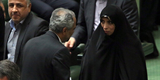 Iranian Vice President for legal matters Elham Aminzadeh (R) attends parliament session to discuss the President's proposed c
