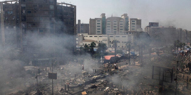 CAIRO, EGYPT - AUGUST 14: Plumes of smoke rise from the site of a protest in support of deposed Egyptian President Mohammed Morsi during a violent crackdown by Egyptian Security Forces on a pro-Morsi sit-in demonstration at the Rabaa al-Adweya Mosque in the Nasr City district on August 14, 2013 in Cairo, Egypt. An unknown number of pro-Morsi protesters were killed in Egypt's capital today as Egyptian Security Forces undertook a planned operation to clear Morsi supporters from two sit-in demonstrations in Cairo where they have camped for over one month. Egyptian Police and Army forces entered protest sites in the Nasr City and Giza districts at dawn using tear gas, live fire and bulldozers to disperse protesters and destroy the camps. A state of emergency has been declared in Egypt to begin this afternoon and will reportedly last for one month. (Photo by Ed Giles/Getty Images)