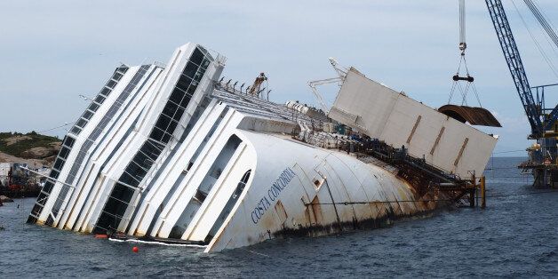 (FILES) This file picture taken on May 27, 2013 shows works in progress to remove the Costa Concordia cruise ship wreck on Giglio island. AFP PHOTO / FILES / VINCENZO PINTO (Photo credit should read VINCENZO PINTO/AFP/Getty Images)