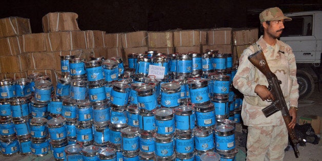 A Pakistani paramilitary soldier stands beside the seized bomb making material in Quetta on August 20, 2013. Paramilitary forces on August 20 seized more than 100 tonnes of bomb-making chemicals from a truck and a compound in southwest Pakistan and detained 10 suspects, officials said. AFP PHOTO / BANARAS KHAN (Photo credit should read BANARAS KHAN/AFP/Getty Images)